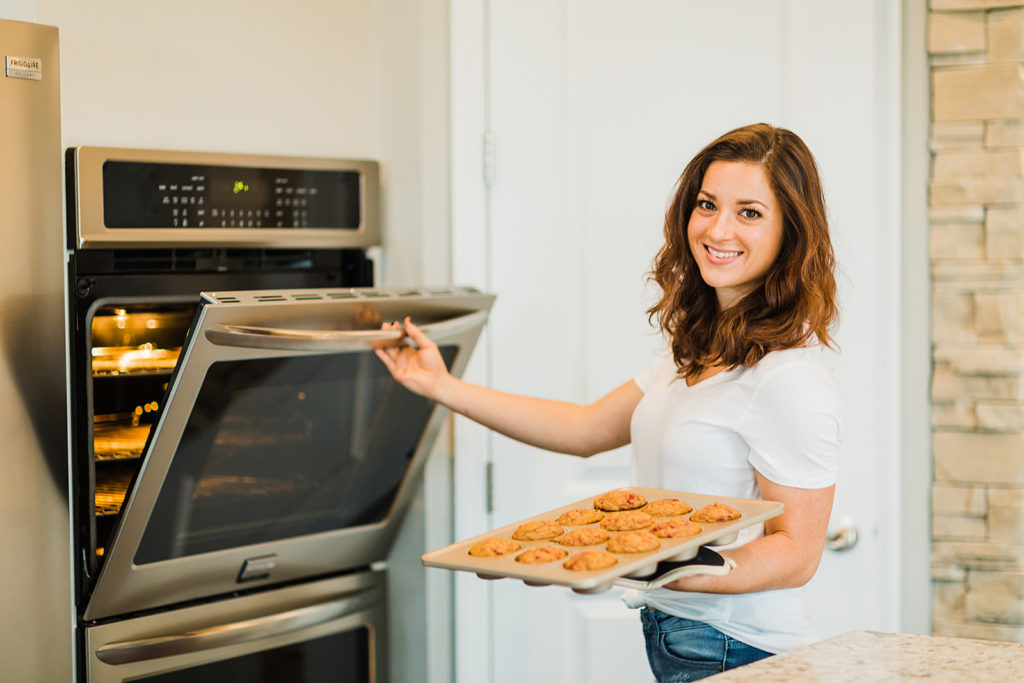 Jen Lyman, dietitian and owner of New Leaf Nutrition, pulls muffins out of the oven