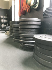 Stack of rubber circular weights inside of Donovan's Strength and Conditioning