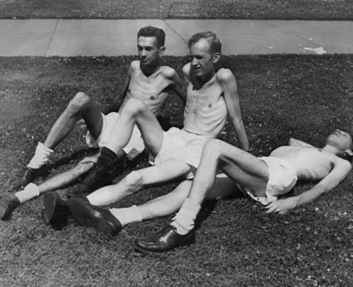Three emaciated men sunbathing during starvation period of the Minnesota Starvation Experiment
